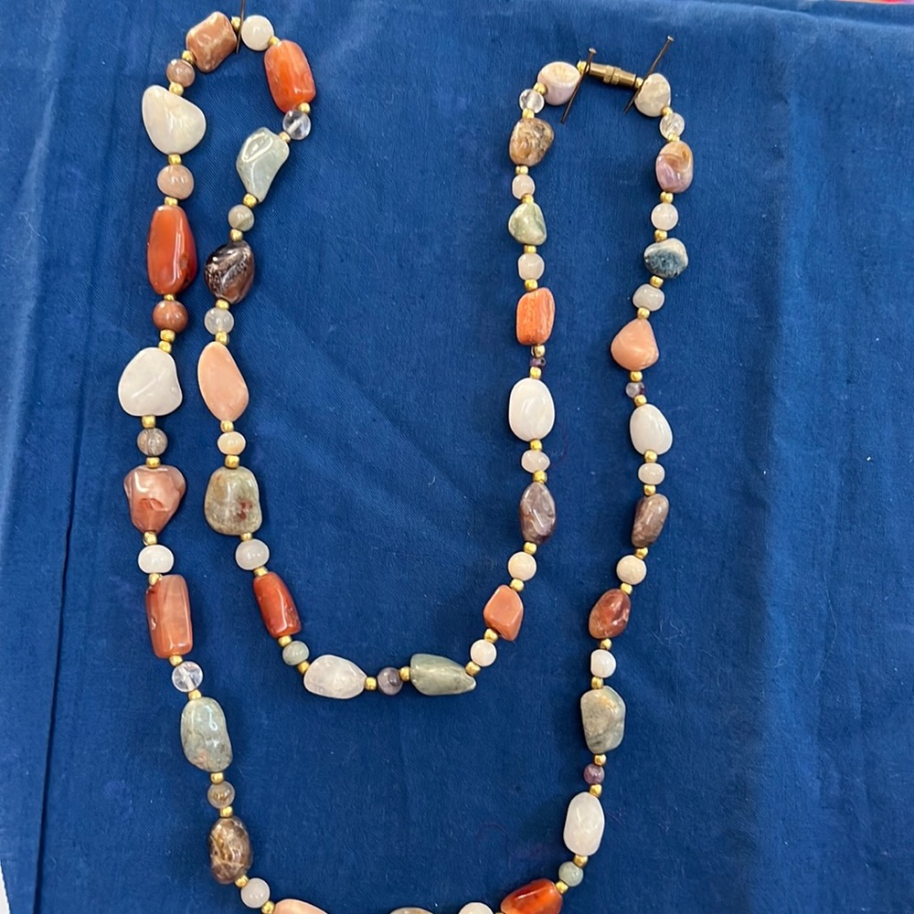 32” necklace made with different natural stones of various colors and types.